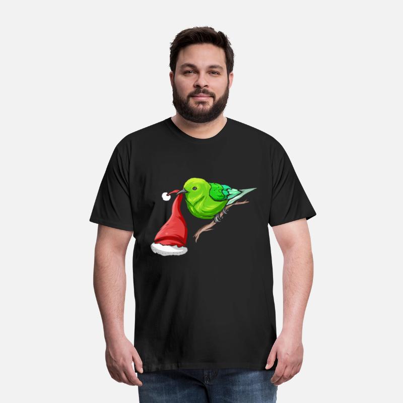 Little Green Bird Carrying Santas Hat In Beak On